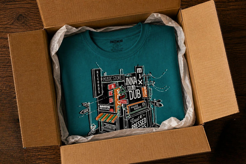 Open box with t-shirts in wrapped in tissue paper