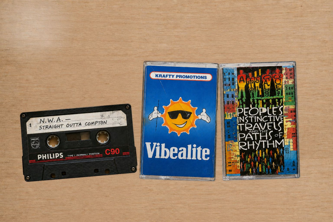 N.W.A, Vibealite and Tribe Called Quest cassette tapes on a wooden table