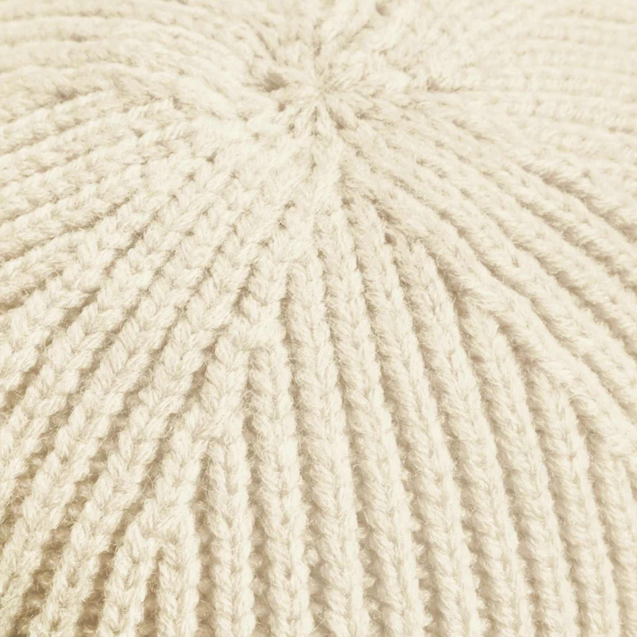 Close-up of beige yarn with a textured pattern
