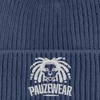 Blue knit beanie with white embroidered logo and text on a blue background