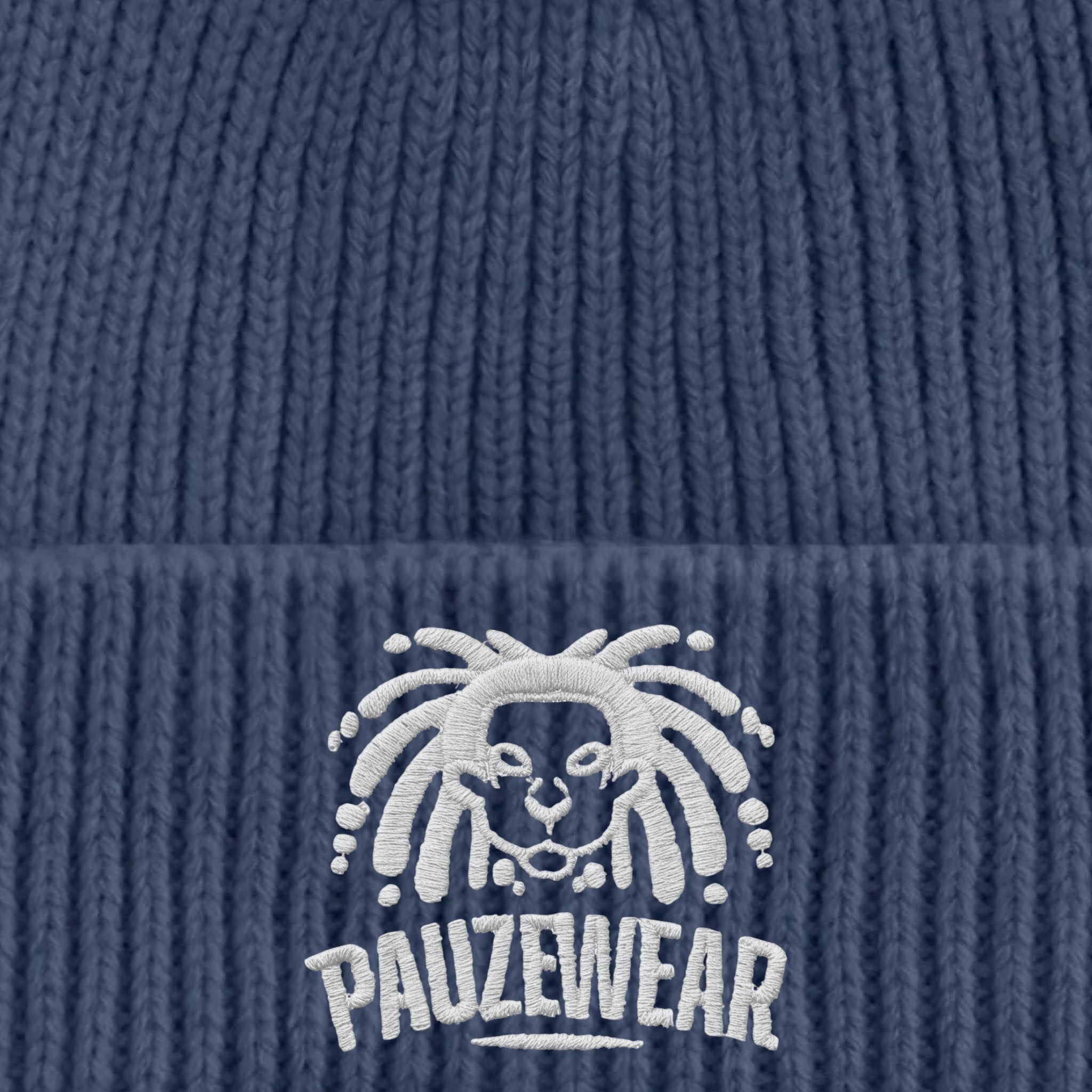Blue knit beanie with white embroidered logo and text on a blue background