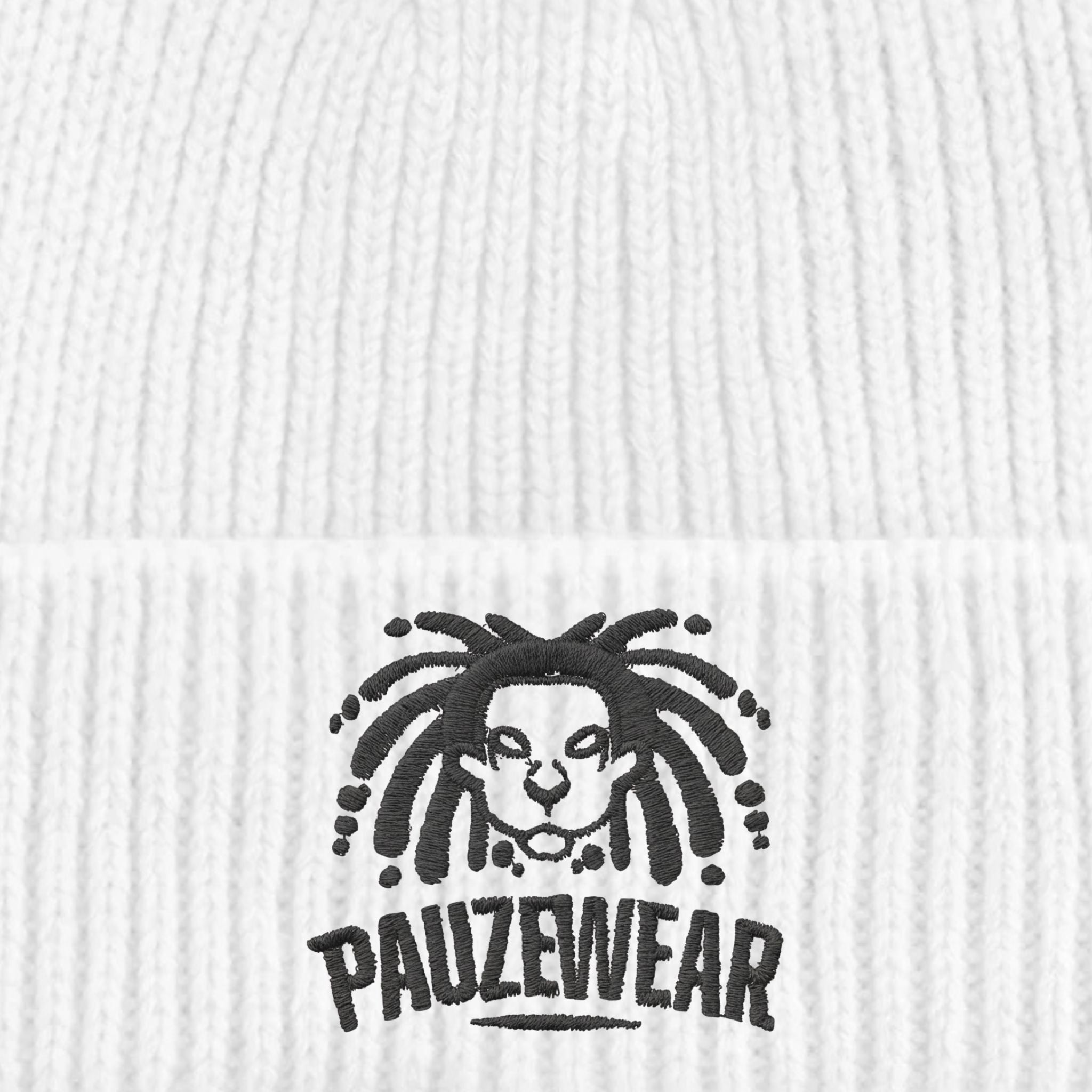 Close-up of a white beanie with a black logo and text on a textured white background
