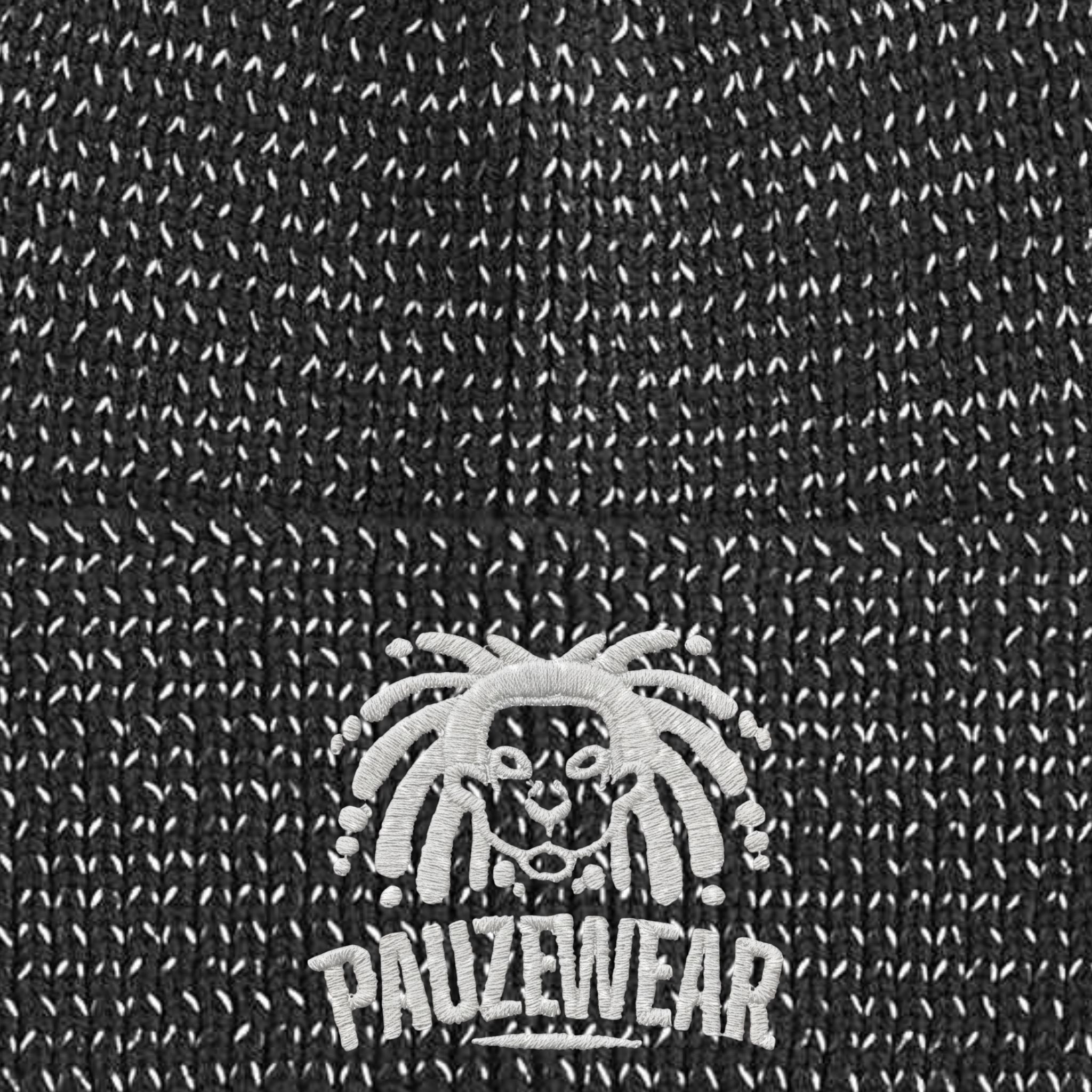 Close-up of a textured reflective black fabric with a white logo and text.