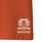 Close-up of an orange garment seam with a cream logo and text on a white background