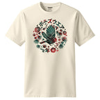 An off-white short-sleeve crewneck t-shirt featuring a circular graphic on the chest with a bird, tropical leaves, flowers, and Japanese text.